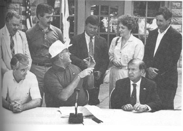 governor James R. Thompson gins IAPD executive
 director Ted Flickinger the pen he used to sign into law on
 October 5, 1989, permanent funding for the Open Space
 Land Aquisition and Development program and the Illinois
 Bikeway Paths